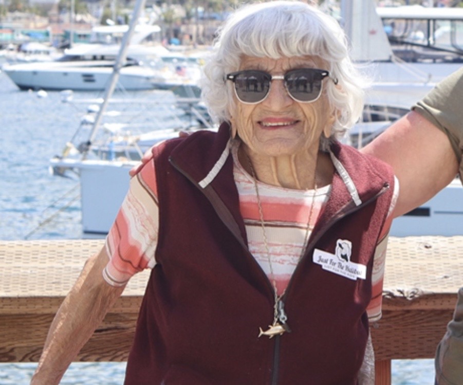 Rosie Cadman, the Queen of Catalina, wearing her signature fish vest at Avalon Harbor